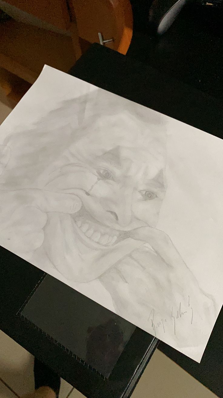 a drawing of a woman's face on a piece of paper