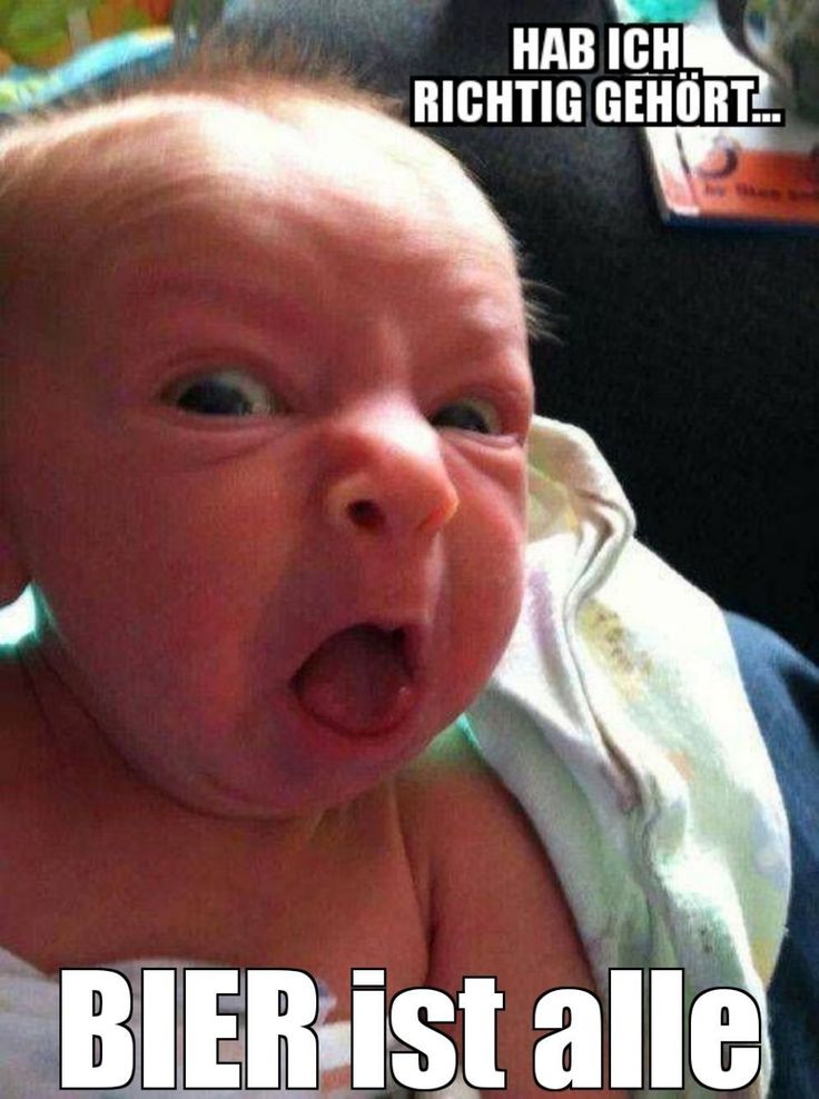 a baby with its mouth wide open in front of a sign that says otan baeniez