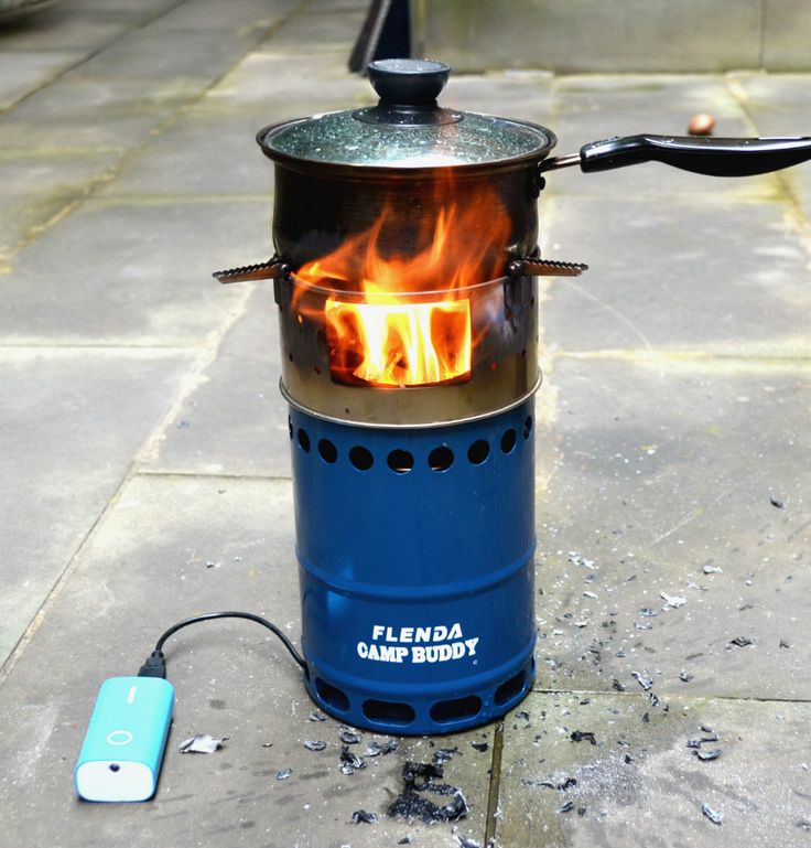 a blue stove sitting on top of a cement floor next to a small light bulb