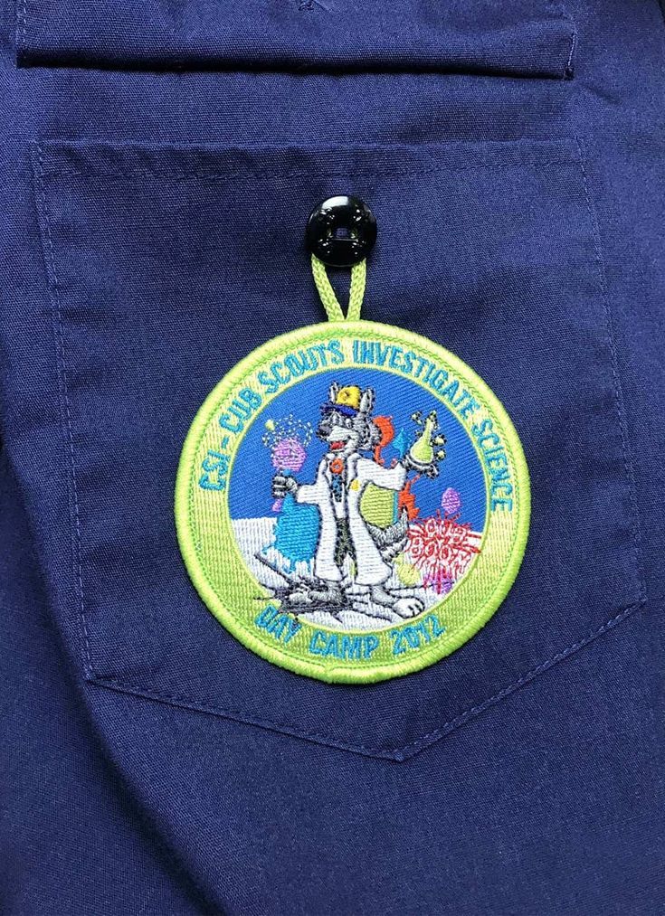 a badge on the back of a man's blue jacket with an image of a cartoon character