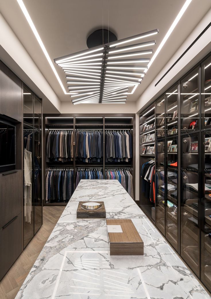 a walk in closet with marble counter tops