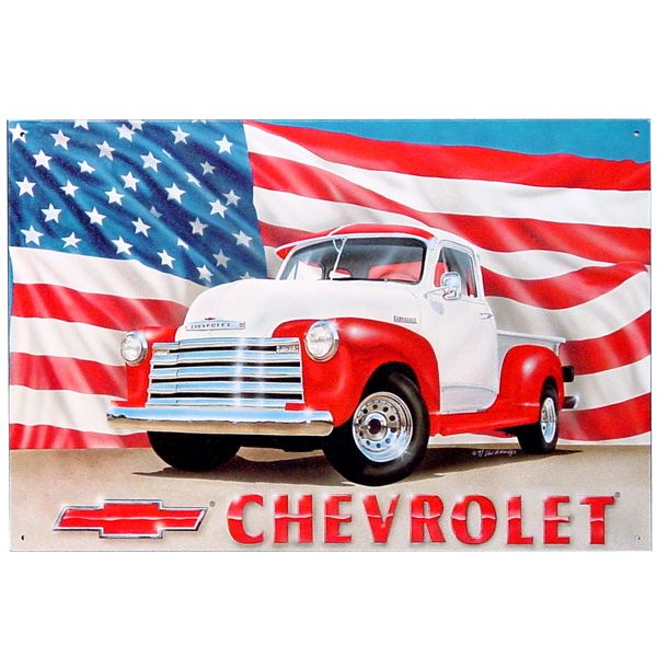 an old chevrolet truck with the american flag in the background