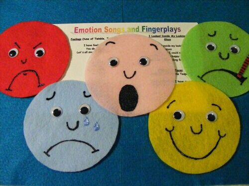 four felt faces with different expressions on them