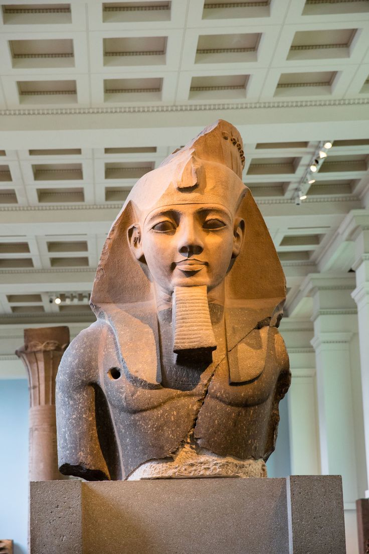 an egyptian statue in the middle of a museum