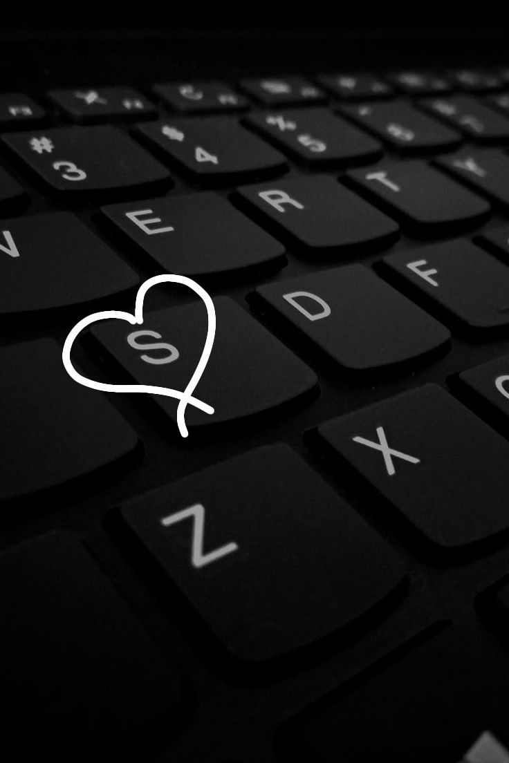 a black keyboard with a white heart on it