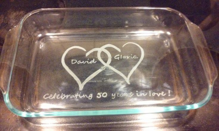 a glass dish with two hearts on it that says, celebrating 50 years in love