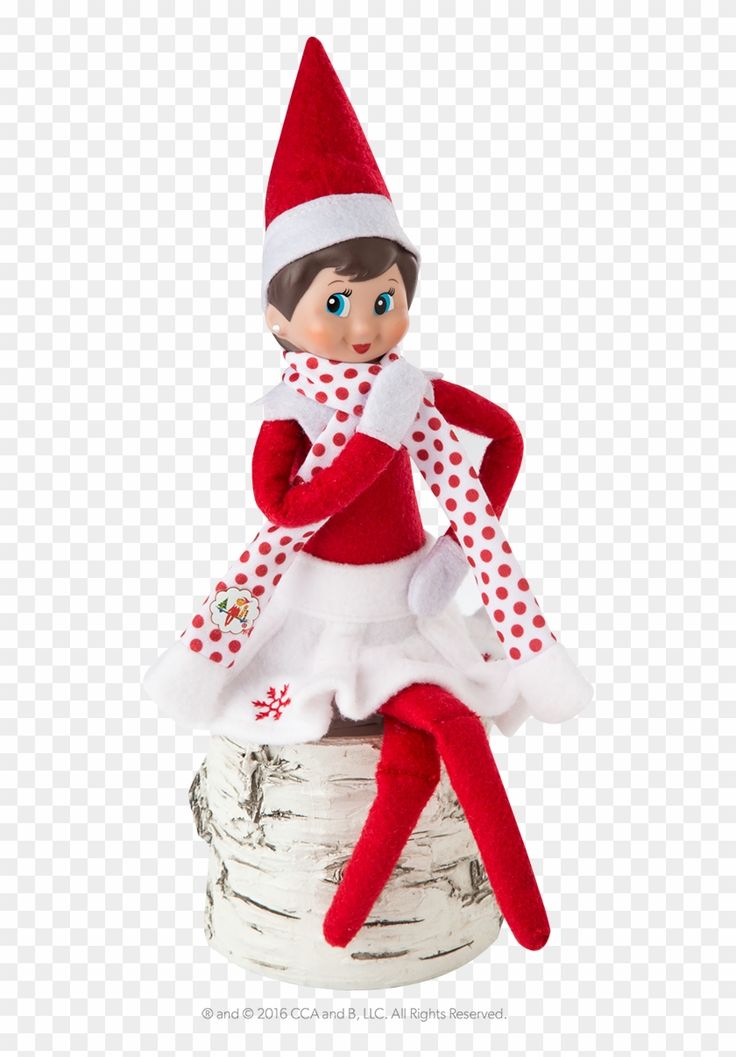 an elf is sitting on top of a birch tree trunk wearing a red and white polka dot