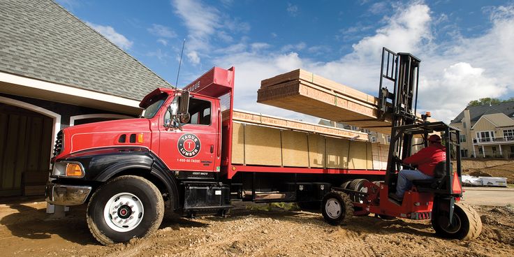 a red truck is parked in front of a house that has been built into the ground