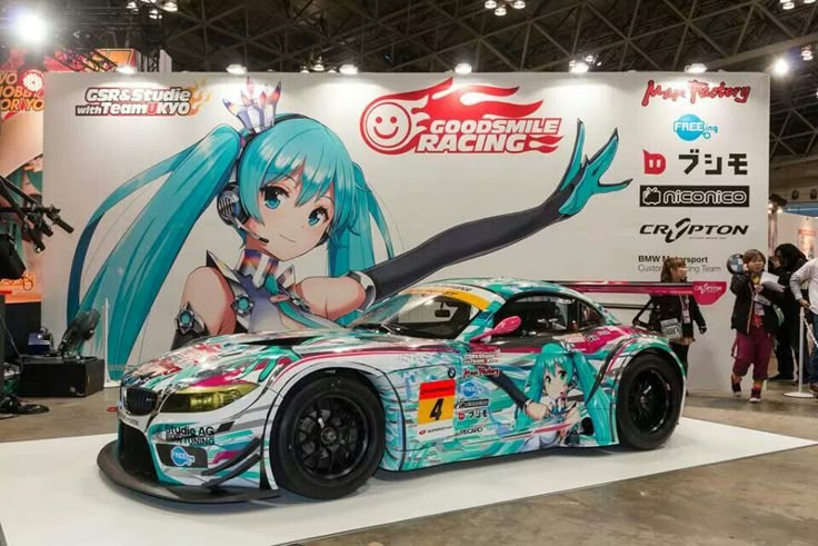 the car is painted with anime characters on it's side and has blue hair