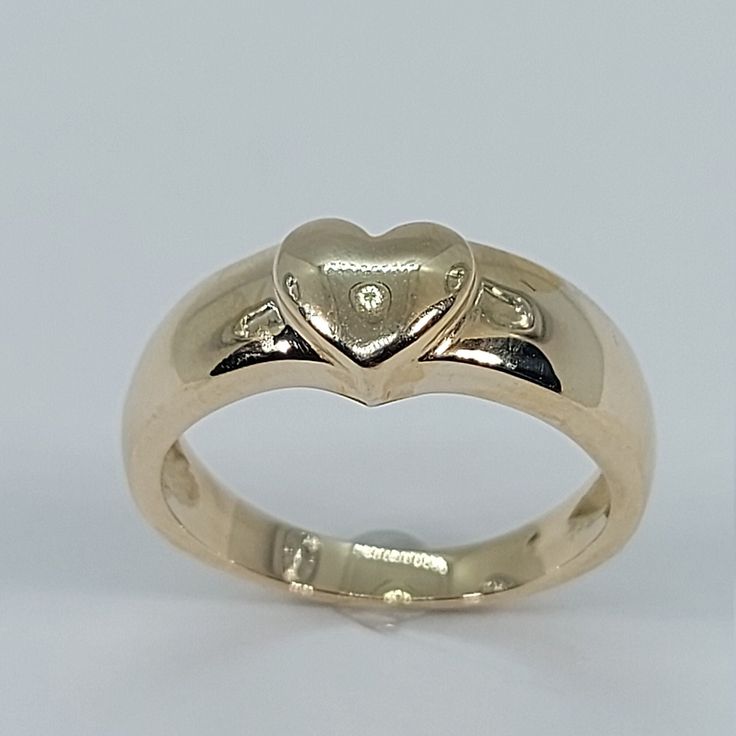 This beautiful heart signet ring has been carefully crafted in 10k Yellow Gold. This delicate ring will make a beautiful any occasion gift. All of my jewelry is handmade from scratch and of high quality. This ring can be personalized with your initials upon request. Ring is size 5 1/2 but I can resize it at no extra cost and will ship it to you in an elegant gift box.    Ring Weight: 3.9 grams Ring Size: 6 1/2 Face of the Ring is 6.9 mm x 7.15 mm  Band at smallest point: 2.5 mm Materials: 10k Ye Hallmarked Heart-shaped Diamond Ring, Heirloom 14k Gold Heart Promise Ring, Classic Heart Cut Signet Ring For Promise, Classic 14k Gold Heart-shaped Signet Ring, Heart-shaped Signet Ring With Polished Finish For Anniversary, Classic Heart-shaped 14k Gold Signet Ring, Classic Heart Shaped 14k Gold Signet Ring, Classic Heart Ring With Polished Finish For Promise, Classic 14k Gold Heart Engraved Ring