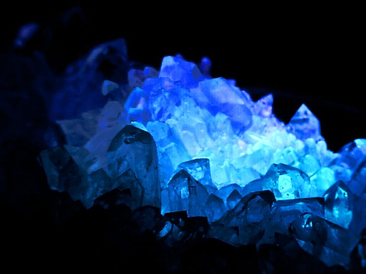 blue and white ice crystals glowing in the dark