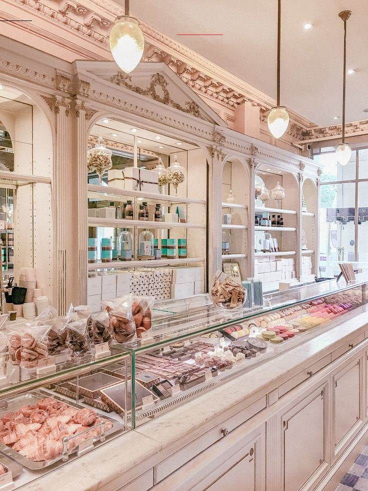 a bakery filled with lots of different types of food on top of glass counter tops