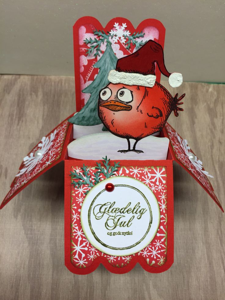 an origami bird with a santa hat on it's head