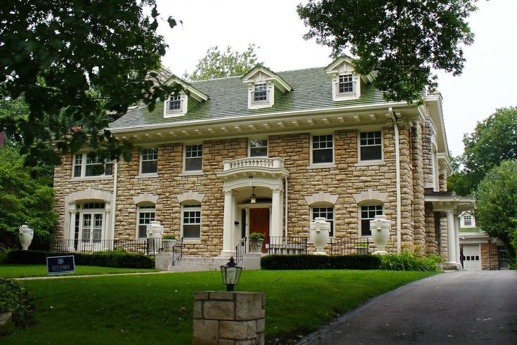 a large brick house with two story windows