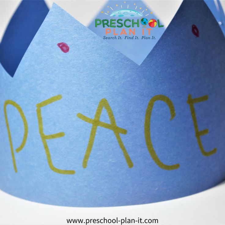 a paper crown with the word peace written on it