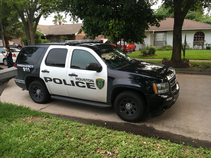 a police car parked in front of a house