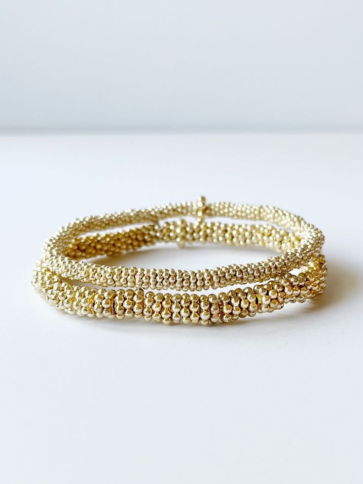 two gold bead bracelets Gold Wrap Bracelet With Tiny Beads As A Gift, Adjustable Gold Stretch Bracelet Hand-strung, Adjustable Hand-strung Gold Stretch Bracelet, Adjustable Gold Stretch Bracelet With Gold Beads, Everyday Gold Beaded Stretch Bracelet, Adjustable Gold Stretch Bracelet Stackable, Adjustable Gold Hand-strung Beaded Bracelets, Gold Stackable Wrap Bracelet Bangle, Adjustable Gold Stretch Bracelet For Everyday