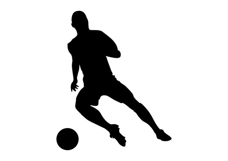 a silhouette of a man kicking a soccer ball