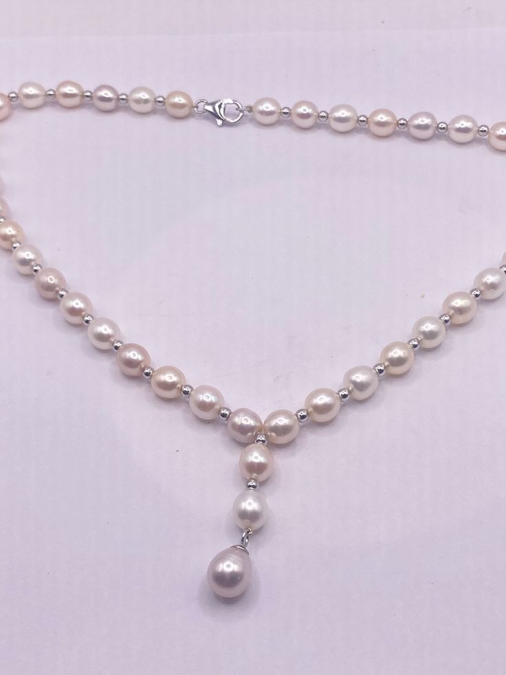 Vintage white Pearl 16 in Necklace Freshwater Pearl necklace with a 2 in center drop. We can add an extension to legthen All jewelry is shipped in a nice gift box. Check out our over a THOUSAND great reviews!!! White Round Drop Necklace For Wedding, Elegant White Sterling Silver Custom Necklace, Formal White Briolette Drop Necklace, White Drop Lariat Necklace With Pearl Drop, White Lariat Drop Necklace With Pearl, White Classic Teardrop Pendant Jewelry, Silver Teardrop Single Strand Necklace, Silver Single Strand Teardrop Necklace, Classic White Teardrop Pendant Jewelry