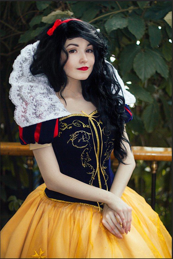 a woman dressed in a snow queen costume posing for the camera with her hand on her hip