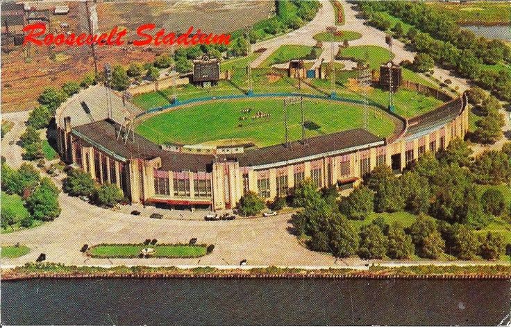 an aerial view of a baseball stadium in the middle of a lake and surrounded by trees