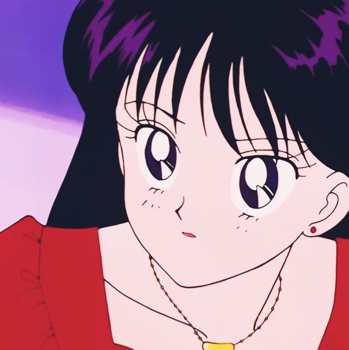 a girl with black hair and blue eyes wearing a red shirt is staring at the camera