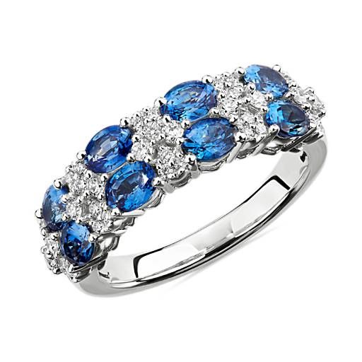 a ring with blue and white stones on it's sides, set in 18k white gold