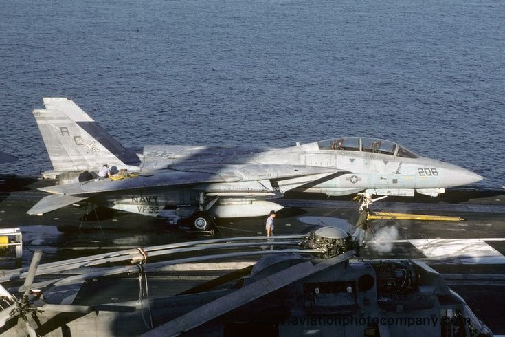 an aircraft carrier with fighter jets on the deck