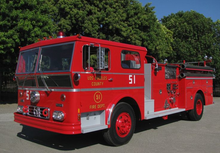 a red fire truck parked in a parking lot