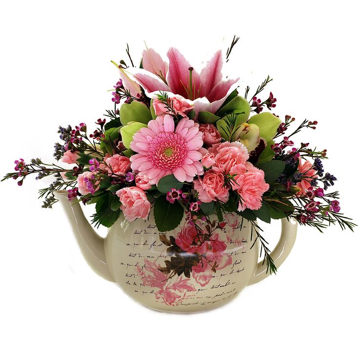 a watering can filled with pink flowers and greenery