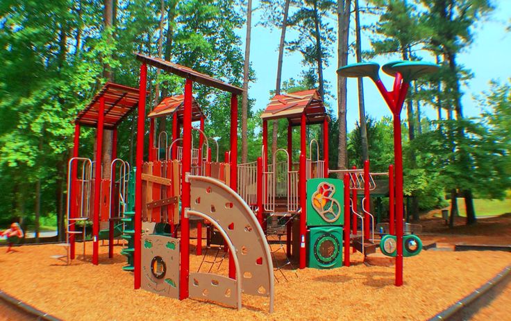 an outdoor play area with swings and slides