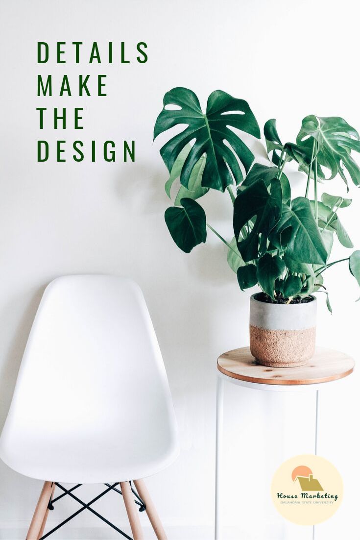 a white chair next to a potted plant with the words details make the design written on it