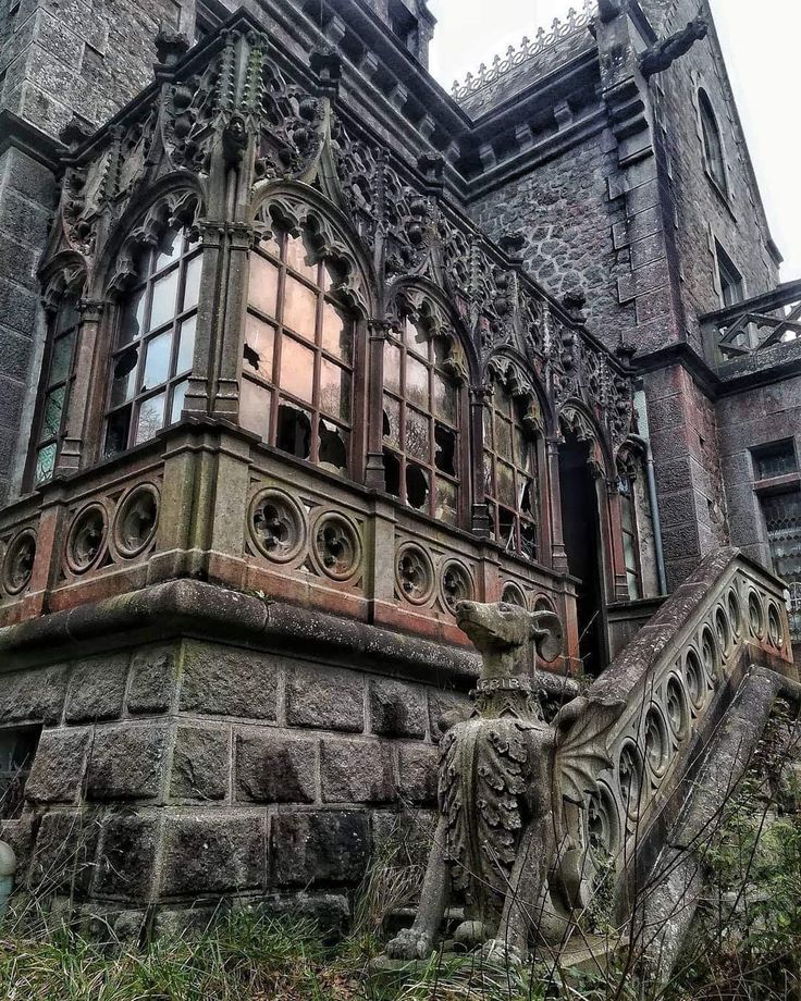 an old building with many windows and statues