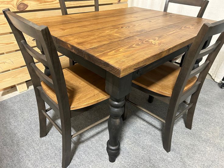 a wooden table with four chairs around it