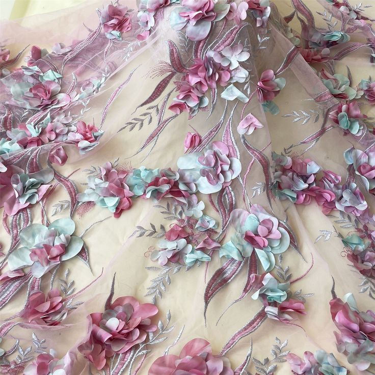 the fabric is covered with pink and blue flowers on white sheer organ - mesh material