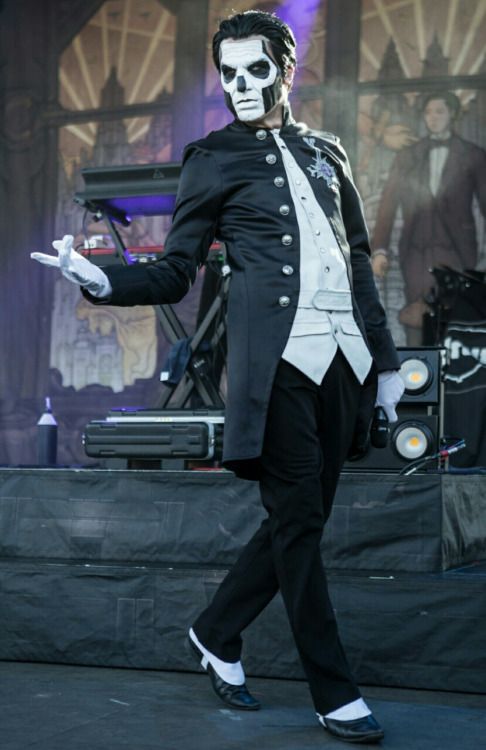 a man dressed in skeleton makeup walking on stage