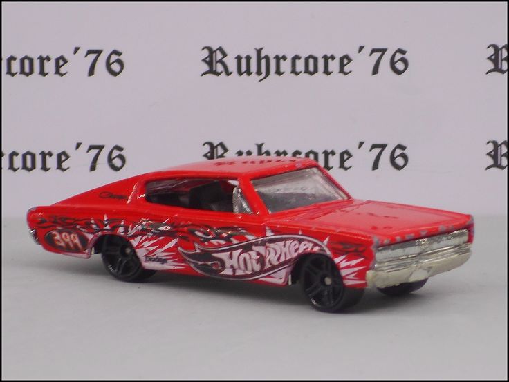 a red toy car with flames painted on it's side and the words hot wheels written in black