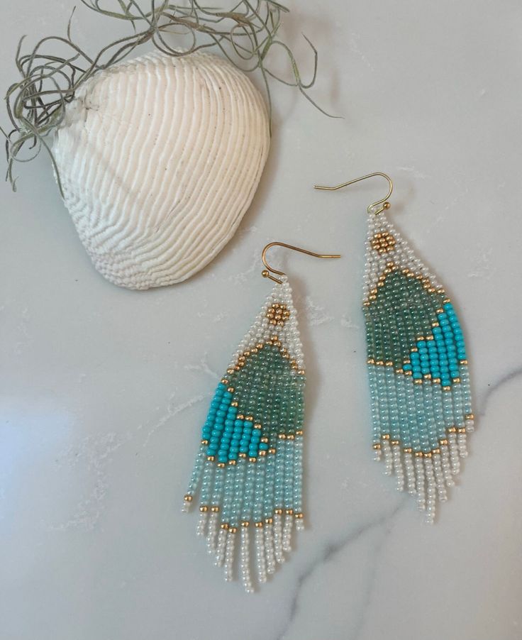 This is a long pair of beads earrings that have a chic beachy vibe. They are great for a night out, beach party, date night, or really any time of the day!  Material: These earrings are made with glass seed beads and Nymo beading thread. They are sturdy and made to last. Color: If you don't like the colors used, I can design your pair with different colors. If you would  rather have this pair of earrings made with shades of pink and orange I will create your pair based on your request. Manufactu Blue Beaded Earrings For Beach In Summer, Blue Beaded Earrings For Beach And Summer, Blue Beaded Earrings For Summer Beach, Bohemian Beaded Dangling Earrings For Vacation, Turquoise Beaded Drop Earrings For Summer, Blue Beaded Earrings With Ear Wire For Summer, Blue Beaded Dangle Earrings For Summer, Summer Beach Tassel Earrings With Beaded Fringe, Summer Beach Tassel Earrings With Dangling Beads