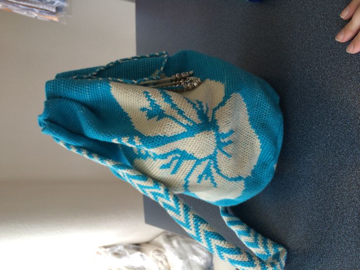 a blue and white bag sitting on top of a table