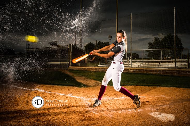 a baseball player swinging a bat at a ball