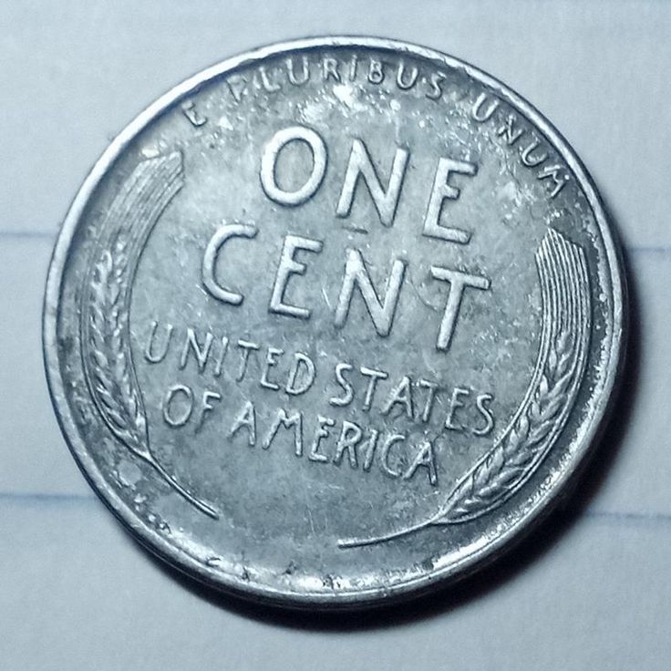 a one cent coin with the words united states of america on it's side