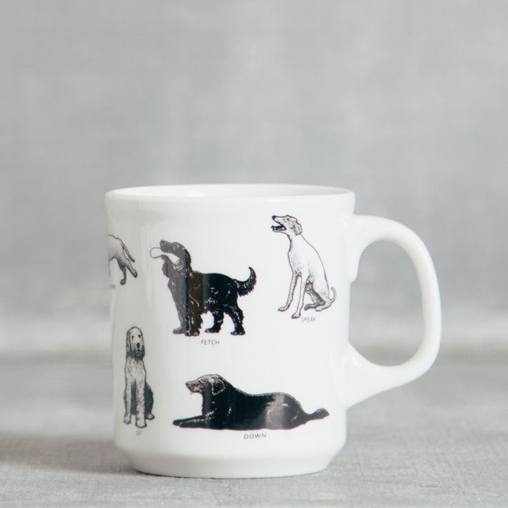 a white coffee cup with dogs on it