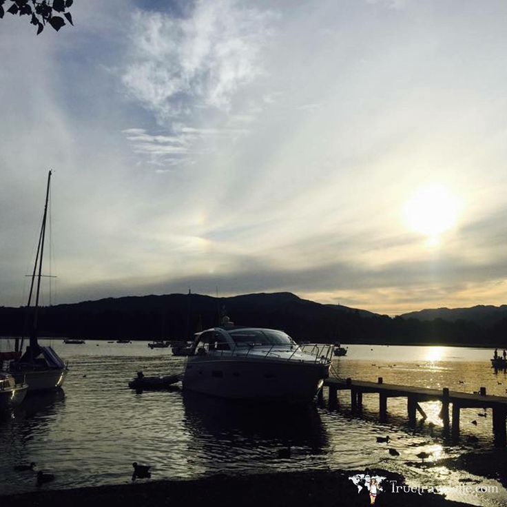 boats are docked in the water at sunset