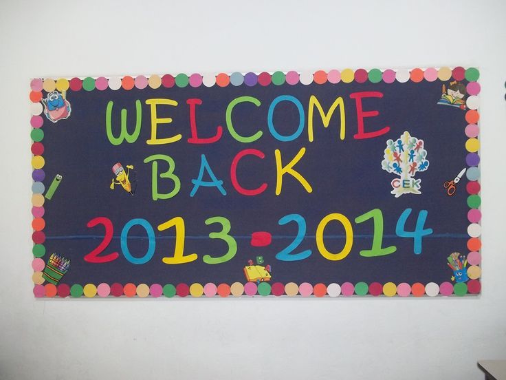 a welcome back sign hanging on the wall