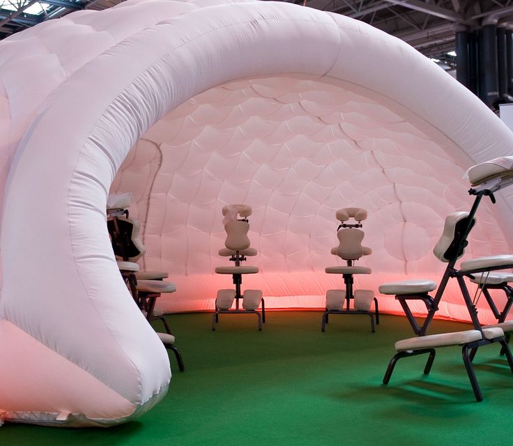 an inflatable tent set up with chairs and tables