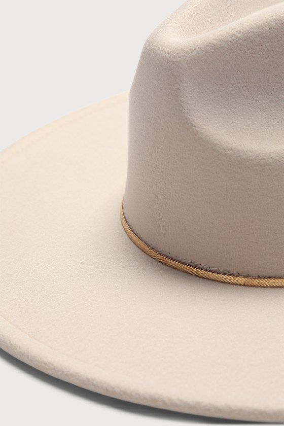 We're saying ""yeehaw"" to style and hitting the road in the Lulus Room to Roam-ance Ivory Fedora Hat! Sturdy felt shapes this stylish hat that features a structured wide brim, teardrop-shaped crown, and a slender, gold-toned metal band that adds a chic finish. 3. 75" Hard Brim. 23" Interior Circumference With Internal Drawstring. Crown Measures 5" Tall. 90% Polyester, 10% Alloy. Imported. Lulus | Room to Roam-ance Ivory Fedora Hat. Felt Shapes, 75 Hard, Wide Brim Fedora, Stylish Hats, Fedora Hat, Metal Band, Wide Brimmed, Metal Bands, Gold Tone Metal