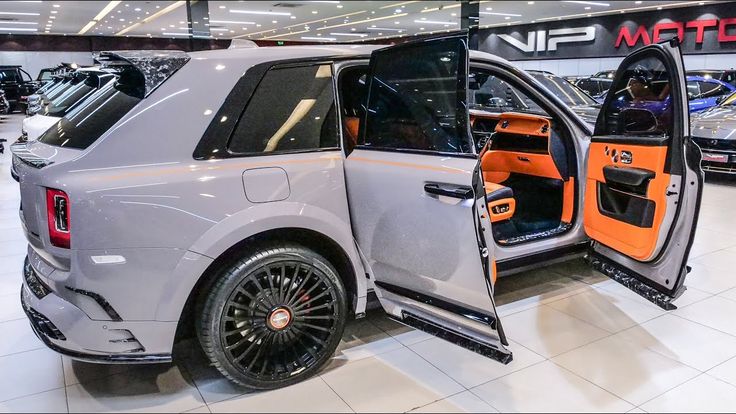 an suv with its doors open in a showroom