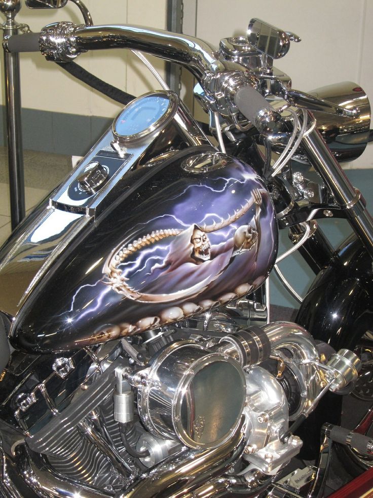 a custom painted motorcycle is parked in a garage