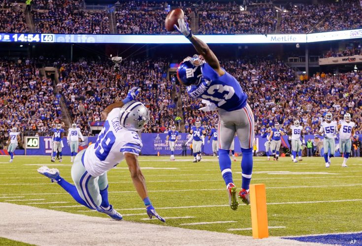 two football players jumping into the air during a game