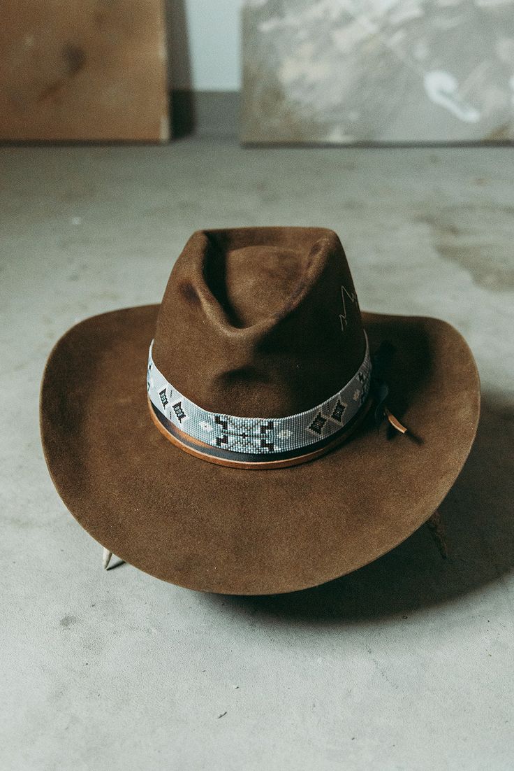 Western 100x in Whiskey with custom distressing and hand shaping 3 1/2" brim Elk leather accent band Hand stitched Mountain detail West hat band sold separately. This felt hat is made to order, please allow 6-8 weeks for delivery. Western Felt Hats, Distressed Brown Fedora For Country Events, Rustic Distressed Brown Hat With Curved Brim, Rustic Hat With Curved Brim In Distressed Brown, Rustic Hat With Distressed Brown Curved Brim, Rustic Hat With Distressed Brown Color And Curved Brim, Distressed Brown Hats With Short Brim For Country Events, Rustic Distressed Brown Brimmed Hat, Distressed Brown Rodeo Hat With Short Brim